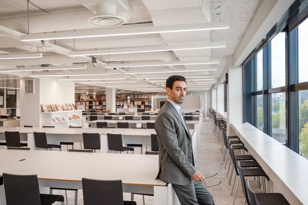 Andrés Mariño Maza in a reading room at the BPI Lumière, with study tables and a window counter along the façade